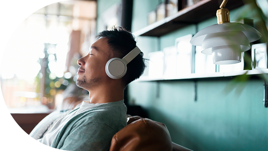 Man sitting down with headphones on.